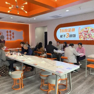 a group of people eating in a restaurant