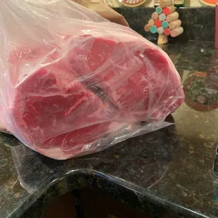 a piece of meat wrapped in plastic