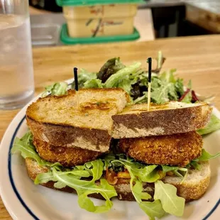 Fried Green tomato sandwich with a side of salad