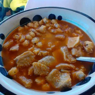 a bowl of soup with meat and beans