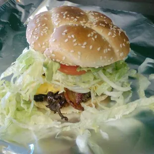 a hamburger with lettuce and bacon