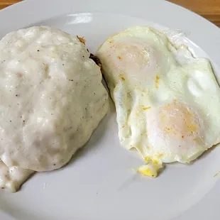 two eggs and gravy on a plate