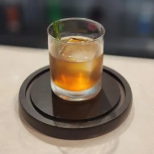 a glass of whiskey on a coaster