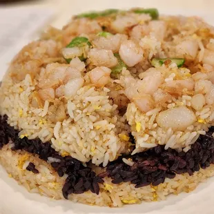 a plate of rice with shrimp and black beans