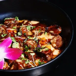 a bowl of food with meat and vegetables