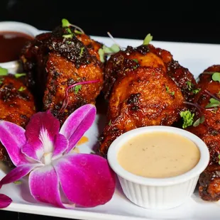a plate of chicken wings with dipping sauce