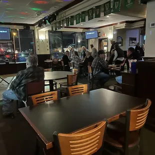 people sitting at tables in a restaurant