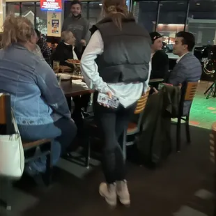 people sitting at tables in a pub