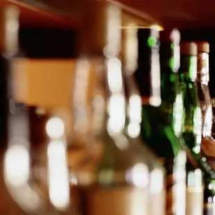a row of wine bottles on a shelf