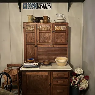 a wooden cabinet with a white countertop