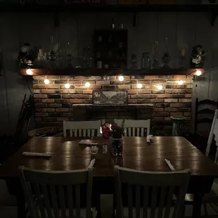 a table and chairs in a dimly lit room