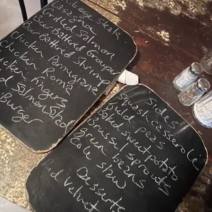 two chalkboards with writing on them