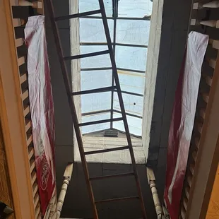 a ladder leading up to a skylight