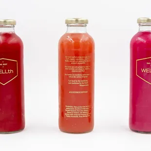 three bottles of juice on a white background