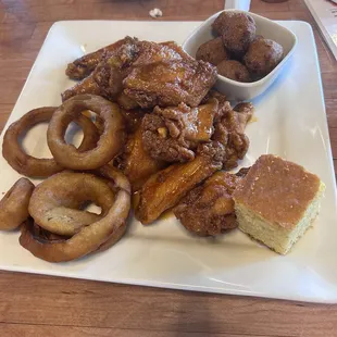 Onion rings, honey hot wings, and hush puppies.