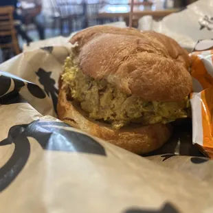 Curry chicken salad sandwich on a croissant