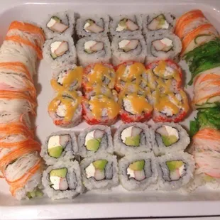 a platter of sushi and rolls