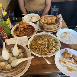 Crispy honey sesame chicken, soup dumplings, 4 seasons chow mein, shumai dumplings, green onion and pork bao buns.