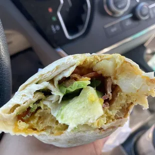 Breakfast burrito with bacon and avocado.