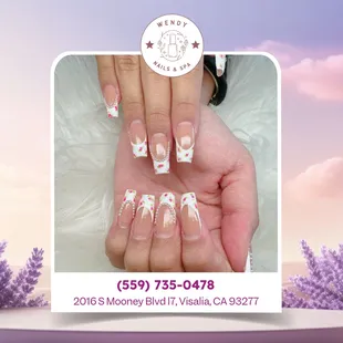 Blooming beauty!Loving this red petal design with a classic white french tip.