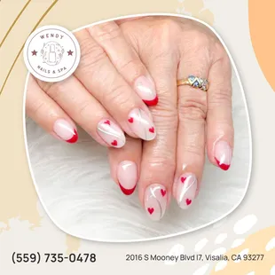 Double the love, double the chrome! Hearts and waves dance on these red french tip nails.