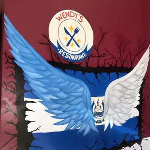 a mural of a blue and white wing