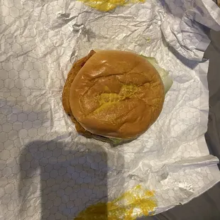 a hamburger with mustard on it