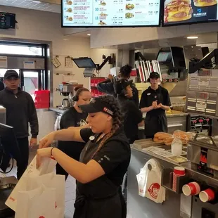 Drive-thru line spilling out onto Iliff. 8 kids in the kitchen. Only 1 making sandwiches. One...