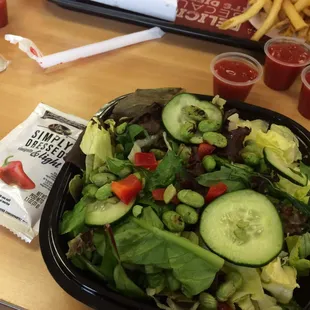 Asian salad: spicy chili vinegarette with spicy cashews, cucumbers, peppers and edamame