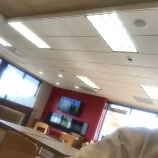 a man sitting in a room with a flat screen tv