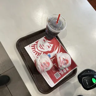 a tray of drinks and a cell phone