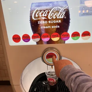 a person using a soda machine