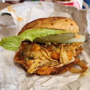 a chicken sandwich with lettuce and pickles