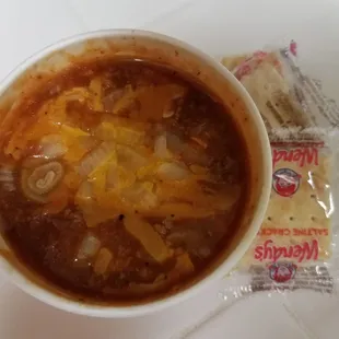 Small cup of Chili with added cheese and onions