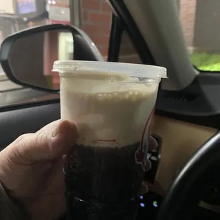 a hand holding a cup of coffee