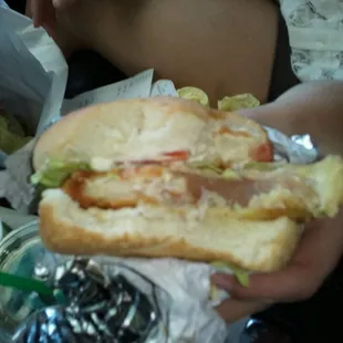 a person holding a sandwich in their hand