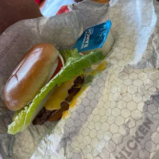 a hamburger with lettuce and cheese