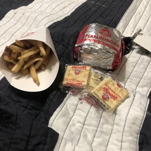 a plate of french fries and a bag of chips