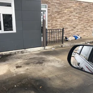 Employee sleeping on the sidewalk because even he can&apos;t get anyone to help him out!