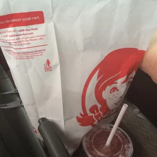 a drink in a plastic cup with a straw
