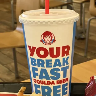 a drink and fries on a tray