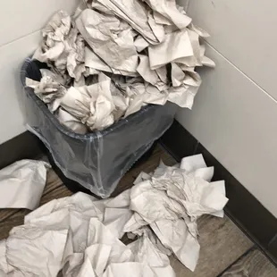 a trash can full of paper