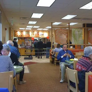 people sitting at tables in a restaurant