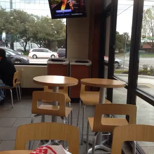 a man sitting at a table in front of a tv