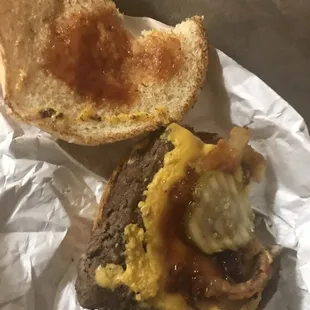 a half eaten burger and half eaten sandwich