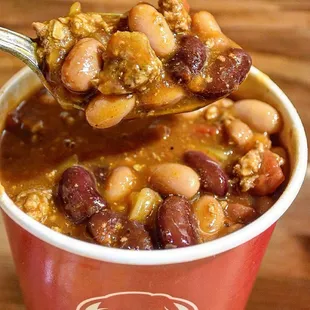 a spoon full of chili and beans