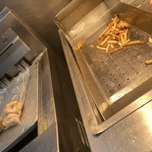 french fries being cooked in a commercial kitchen