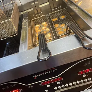 a fryer filled with donuts