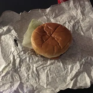 a hamburger and a drink on a table