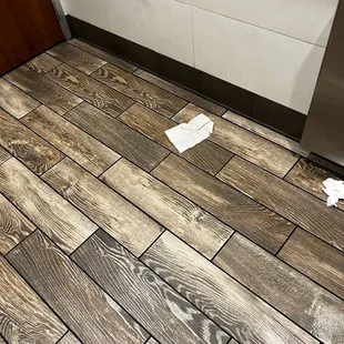 Trash on the bathroom floor